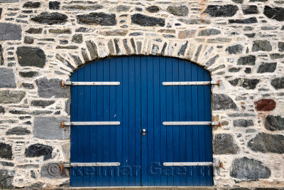 Blue door on stone house at Old Harbourside Portsoy Aberdeenshire Scotland UK