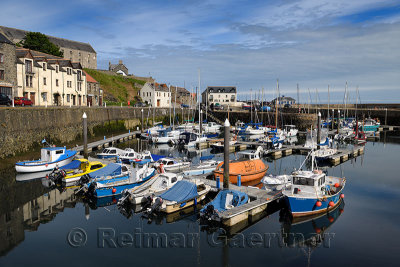 Calm water in the morning at Banff Harbour marina with docked boats and sailboats on Banff Bay Moray Firth Aberdeenshire Scotlan