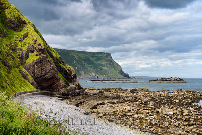 Oyster collectors on Gamrie Bay North Sea with sea cliffs at Gardenstown and footpath to Crovie, Banff, Aberdeenshire, Scotland,
