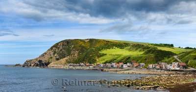 Panorama of single row of houses of Crovie coastal village on Gamrie Bay North Sea Aberdeenshire Scotland UK