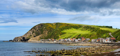 Panorama of single row of houses now holiday lets of Crovie coastal fishing village on Gamrie Bay North Sea Aberdeenshire Scotla
