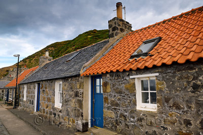 Row of stone houses in coastal fishing village of Crovie Banff Aberdeenshire Scotland UK