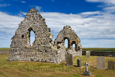 13th Century St Mary Chapel ruins of fieldstone on church grounds with cemetery gravestones at Old Rattray Aberdeenshire Scotlan