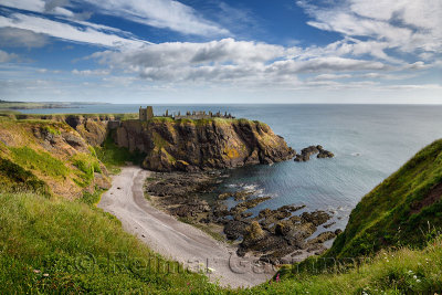 Pebble beach at Old Hall Bay North Sea from clifftop south of Donnottar Castle Medieval fortress ruins near Stonehaven Scotland 