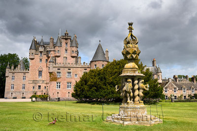 Front lawn of Glamis Castle with wild Ring-necked Pheasant and The Great Sundial with 80 sundials on top and 4 held by Lions Sco