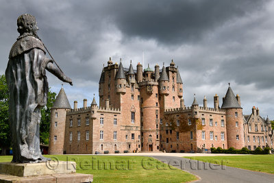 Front lawn of Glamis Castle childhood home of Queen Mother with lead statue of King James I of England and King James VI of Scot