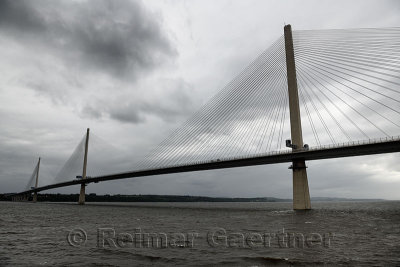 Modern Queensferry Crossing cable stayed suspension bridge over the Firth of Fourth to Edinburgh Scotland UK under stormy gray s