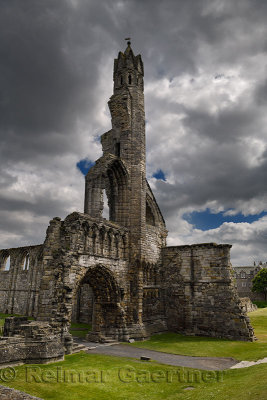 Stone ruins of the 14th Century West Entrance and tower of St Andrews Cathedral with dark clouds St Andrews Fife Scotland UK