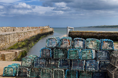 Stone St Andrews Pier at Kinness Burn emptying to the North Sea with Lobster traps on Shorehead road St Andrews Fife Scotland UK