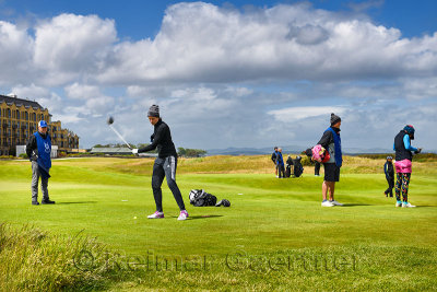 Woman with one arm teeing off on the 18th hole of the Old Course of St Andrews Links the worlds oldest golf course in St Andrews