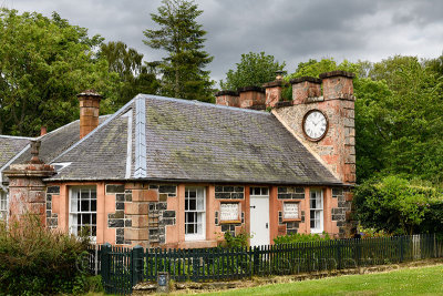 West Clock Lodge in Sheriffmoor Plantation Forest at Eagle Lodge Scottish Borders Scotland UK station house with clock on chimne