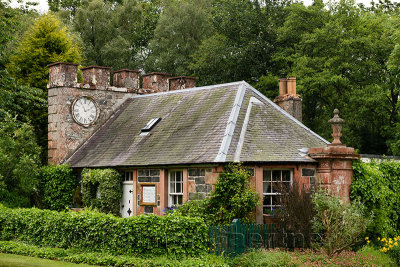 West Clock Lodge coach house in Sheriffmoor Plantation Forest at Eagle Lodge Scottish Borders Scotland UK with ivy and clock chi