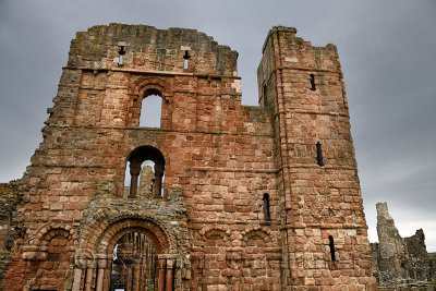 Front of Lindisfarne church and monastery ruins of the medieval priory with cross arrow loops on Holy Island of Lindisfarne Engl