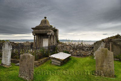 Clouds over cemetery at The Parish Church of Saint Mary the Virgin on tidal Island of Holy Island of Lindisfarne England UK