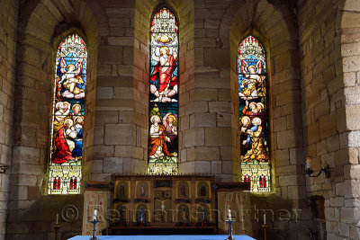 The Parish Church of Saint Mary the Virgin altar with stained glass windows depicting Ascension of Jesus Holy Island of Lindisfa