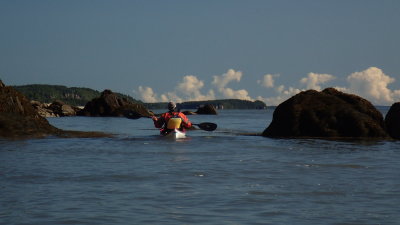 Paddling through rocks at base of lighthouse