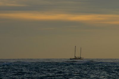 Sailboat making way at sunset