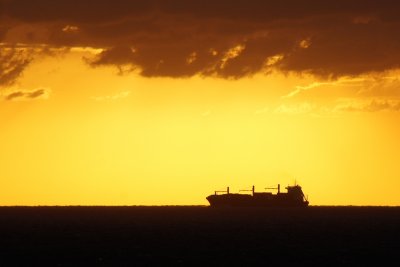 Tanker silhouetted in brilliant sunset