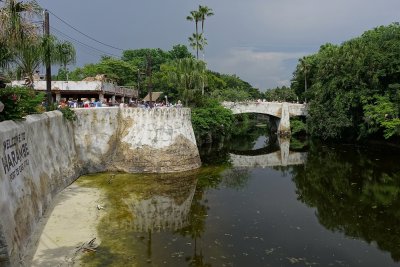 Down Harambe river wall to bridge