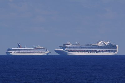 Two cruise ships passing in the distance