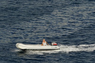 Sailor in his dingy, heading to shore