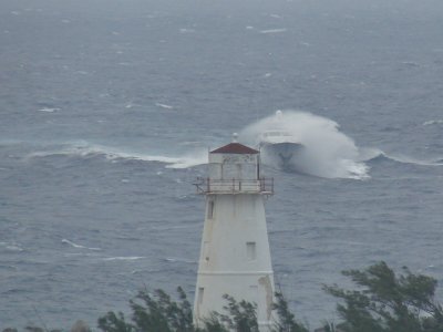 Waves crash over Olga as she steers for port