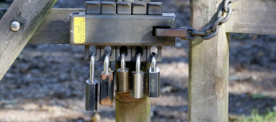 Locks on a gate to an empty field.
