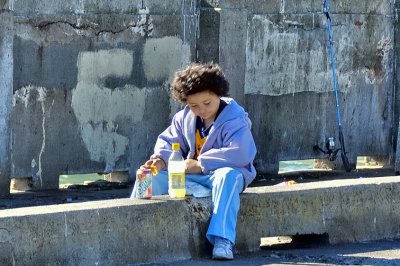 Having A Snack While Fishing On The Sea Wall