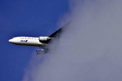 ANA's B-777/200, JA711A, Emerging From The Clouds