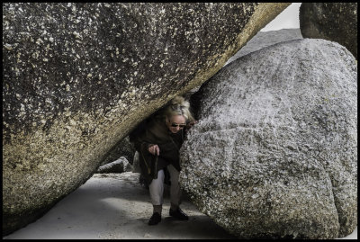 Karen squeezing thru boulders at penguins.jpg