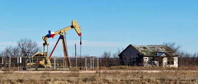 Derelict house, though the oil derrick looks in pretty good shape