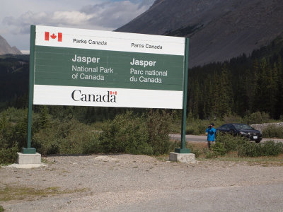 Taking a picture of the sign for Banff National Park on the other side