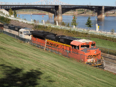 A coal train passes the Arch and the river