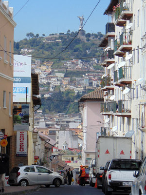 Quito street with the statue of the Virgin Mary on the hill