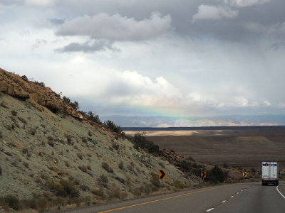 A clear patch of sky and partial rainbow on Interstate 70