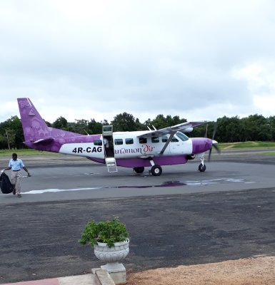 My bag is carried off the Cessna. Sigiriya Airport