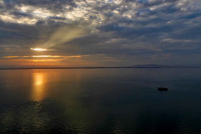 Sunrise over a calm Paracas Bay, Peru