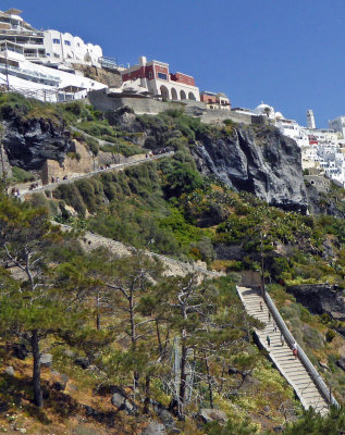 People and Donkey climbing the 588 Steps up to Fira Town