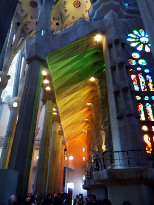 Warm color reflections from Stained Glass on the ceiling in the Sagrada Familia
