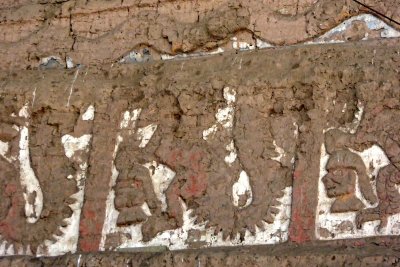 Removing mud from the Murals without damaging the colors is slow work