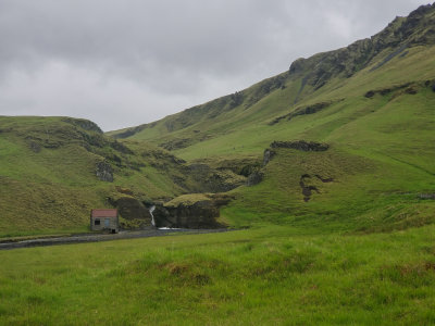 Waterfall and shed Iceland South coast. East of Skaftrhreppur