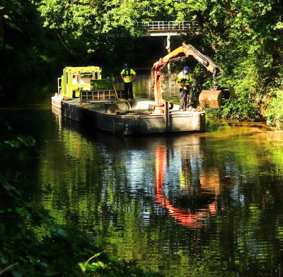 A  cleaner-upper  boat  reflected  in  the  river.