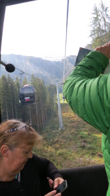 Ann , checks  her  timepiece, in  the  cablecar.