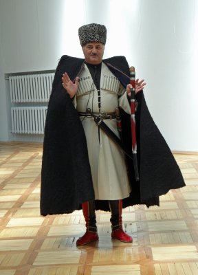 In Kabardino-Balkharia, a museum director is wearing traditional Circassian clothing.
