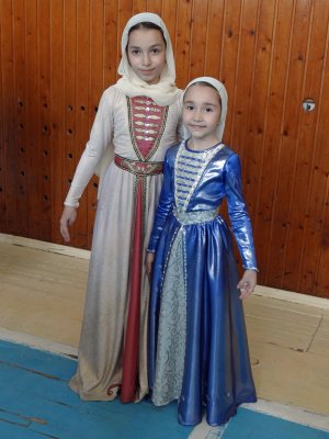 Traditional costumes.  Girls dance in an extremely graceful way, always with their arms out and their eyes downcast.