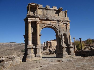 Djemila's arch with a temple in the background.