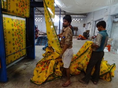 Sarees rolling off a printing line