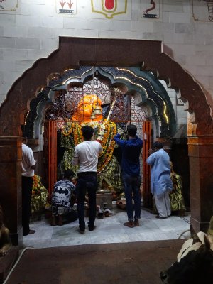 Worshippers at a small shrine to Hanuman