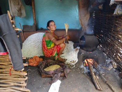 This woman is puffing rice, which tastes much like our popcorn.