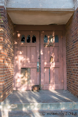 Some of the door panels have been replaced but now the door windows have been broken out.